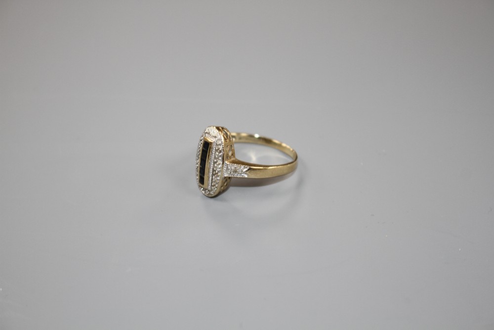 A modern Art Deco style 9ct gold, sapphire and diamond set oval dress ring, size Q/R, gross weight 3.3 grams.